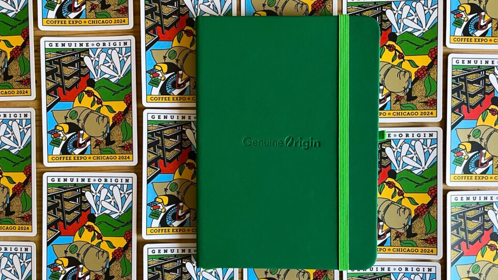Green Genuine Origin notebooks resting on GO EXPO 2024 stickers